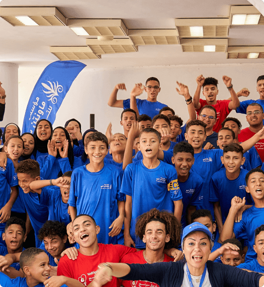 Group of people smiling and raising their hands